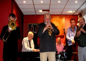 8th March 2015. The Raynes Park Jazz Band playing a Sunday afternoon session at the Prince George Club in Raynes Park. Mike Pointon, trombone, Mike, piano, Chez Chesterman, trumpet/leader, Harry Brown, drums, Mike Godwin, bass and Tony Pike, clarinet & alto sax.